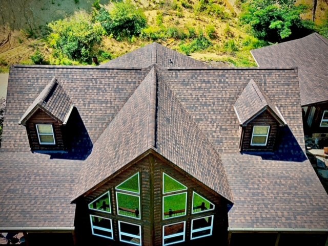 Aerial of a log cabin with new architectural shingle roof