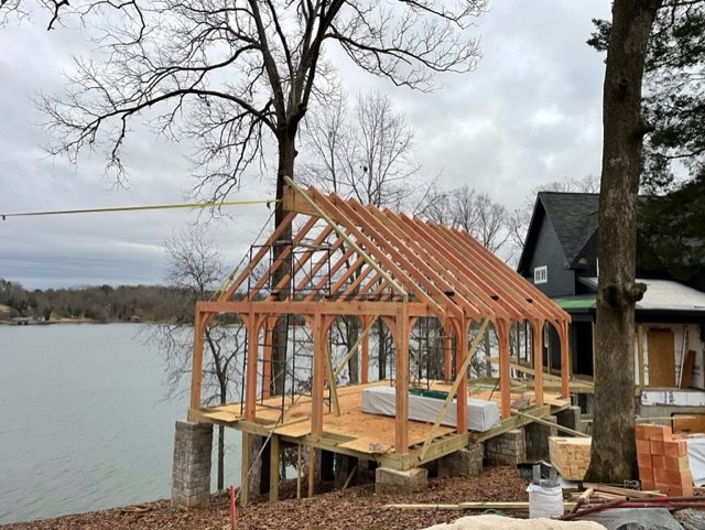 Lakeside timber-frame structure under construction