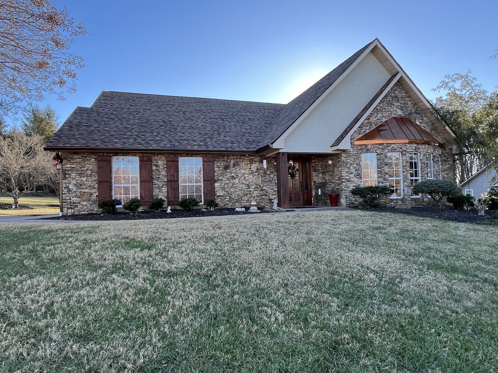 Stone home with copper roof accents